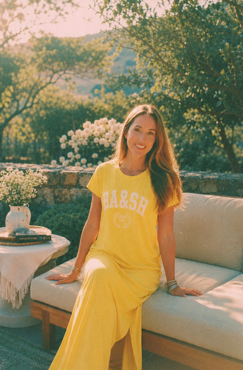Sarah Leah seated outdoors in a garden.